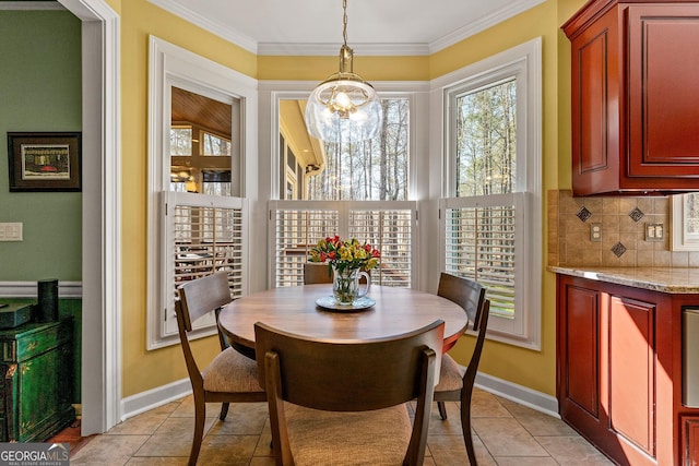 dining room with light tile patterned flooring, baseboards, and ornamental molding