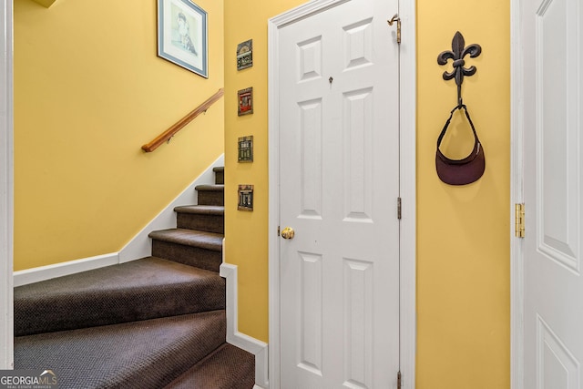 staircase with carpet and baseboards