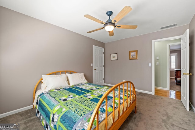 bedroom with a ceiling fan, baseboards, visible vents, and carpet floors