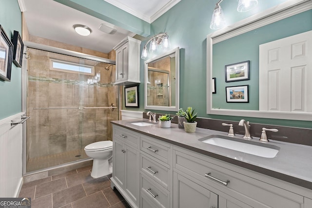 full bath featuring double vanity, a shower stall, toilet, and a sink