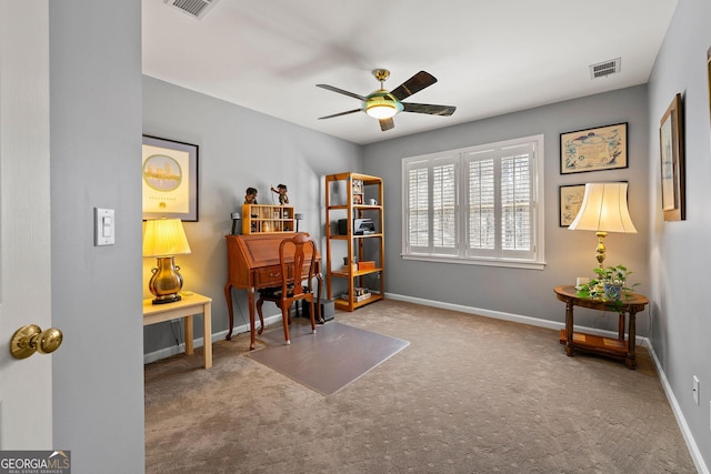 office featuring a ceiling fan, carpet, visible vents, and baseboards