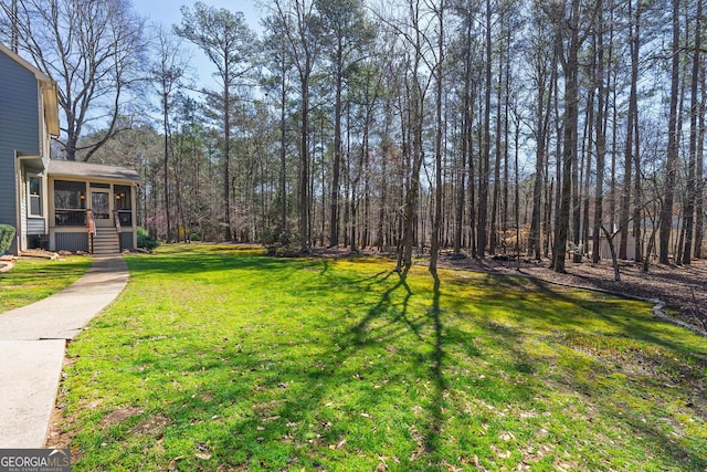 view of yard with a sunroom