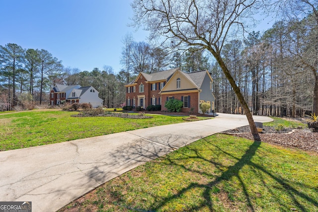 view of front of house with brick siding and a front yard