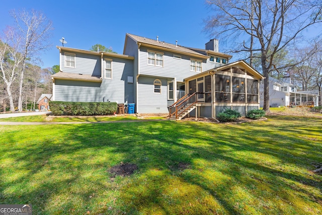 rear view of house with stairway, a yard, a sunroom, a chimney, and crawl space