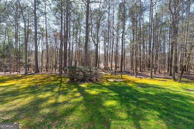 view of yard with a forest view