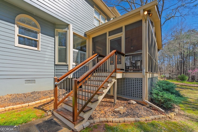 deck featuring stairway and a sunroom