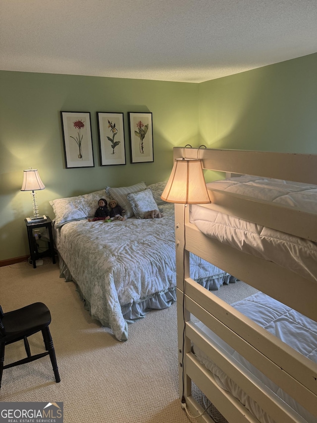 bedroom featuring carpet flooring and a textured ceiling