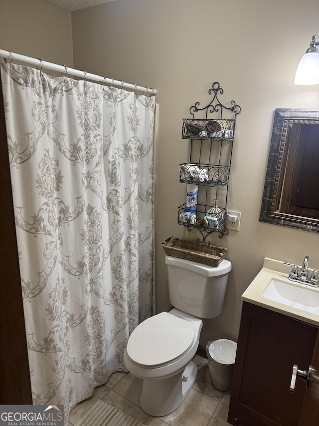 full bath featuring tile patterned floors, a shower with curtain, toilet, and vanity