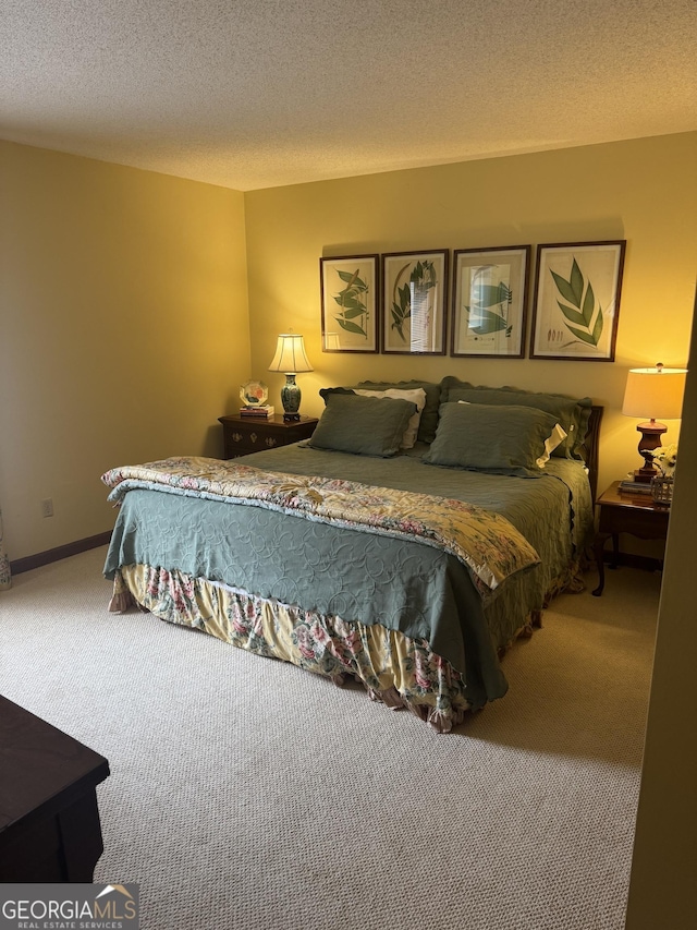 bedroom with baseboards, carpet, and a textured ceiling