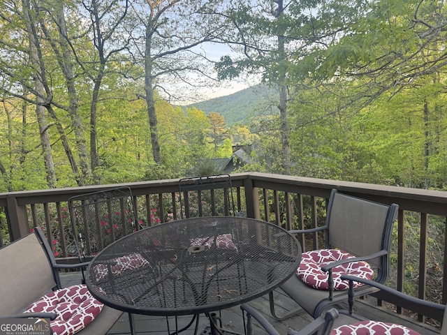 63 Mashie Ln, Sky Valley, GA 30537 - wooden terrace with outdoor dining space and a forest view