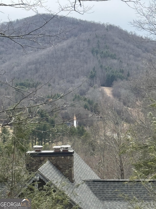 mountain view featuring a view of trees