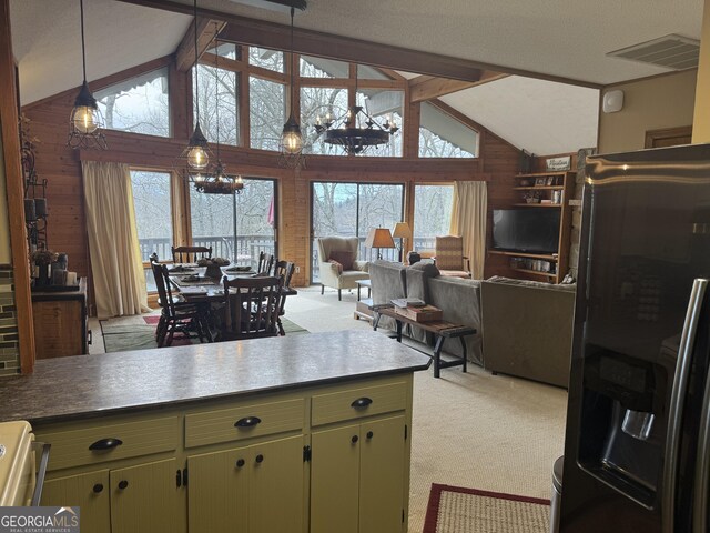 63 Mashie Ln, Sky Valley, GA 30537 - kitchen with black refrigerator with ice dispenser, light carpet, wood walls, green cabinetry, and open floor plan