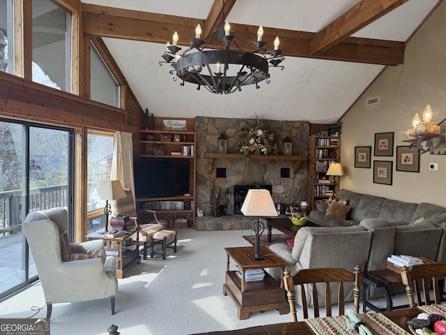 living room featuring visible vents, beamed ceiling, carpet floors, a stone fireplace, and a notable chandelier