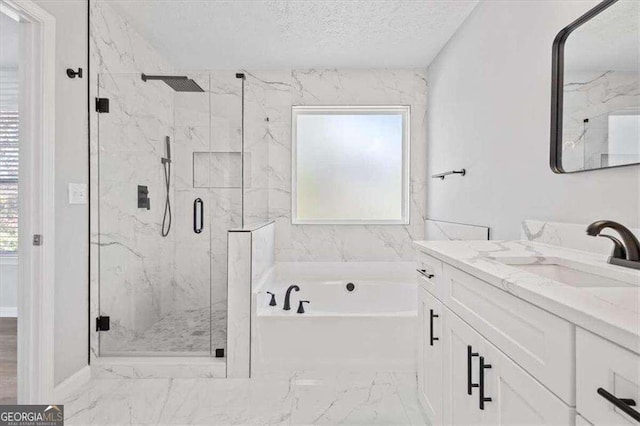 full bath featuring vanity, a garden tub, a marble finish shower, and a textured ceiling