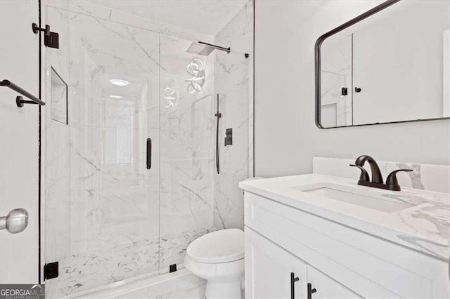 bathroom featuring a marble finish shower, marble finish floor, toilet, and vanity