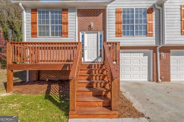 exterior space with an attached garage, brick siding, and driveway