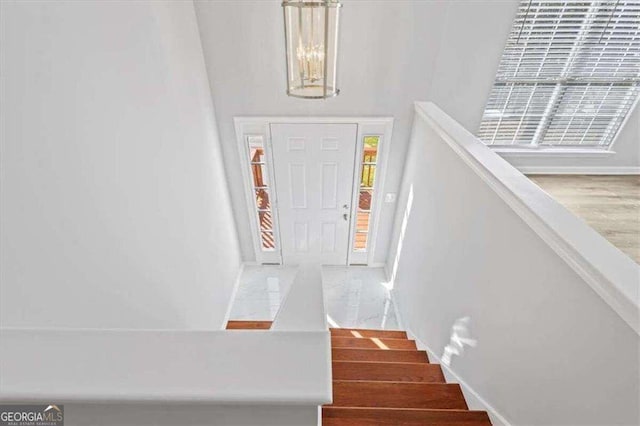 entryway with stairway and baseboards