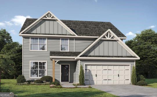 806 Brittany, Nichole Bonaire, GA 31005 - view of front facade with driveway, board and batten siding, a front lawn, and a shingled roof