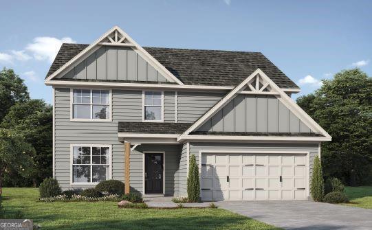 view of front facade with driveway, board and batten siding, a front lawn, and a shingled roof