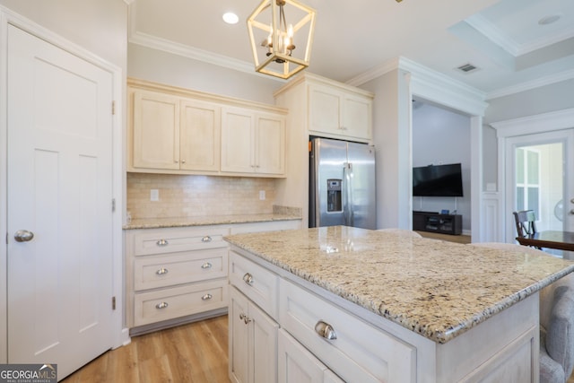 kitchen featuring tasteful backsplash, stainless steel fridge, light wood-style flooring, and ornamental molding