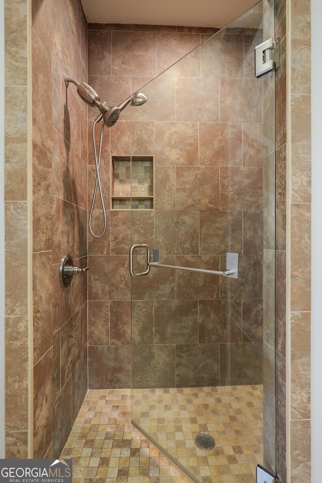 bathroom featuring a shower stall