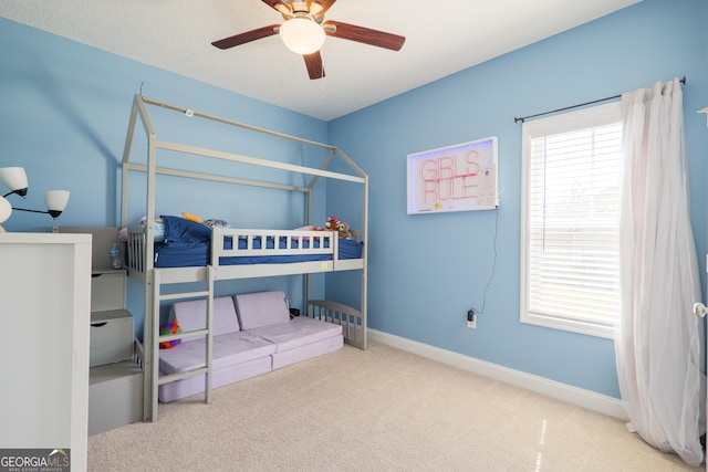 carpeted bedroom featuring baseboards and ceiling fan