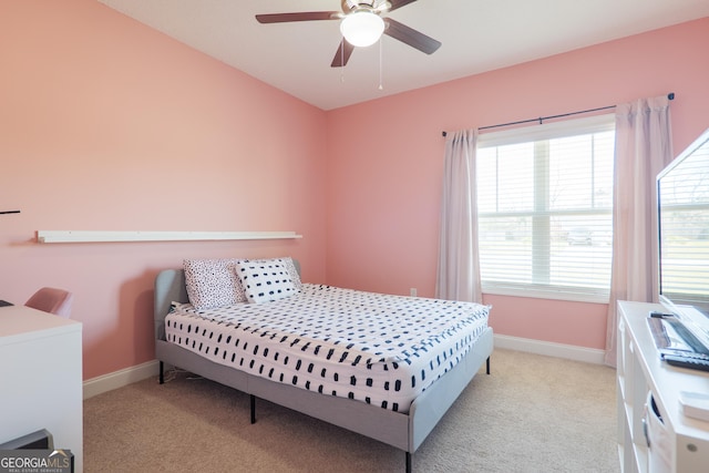 carpeted bedroom with baseboards and a ceiling fan