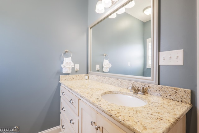 bathroom with baseboards and vanity