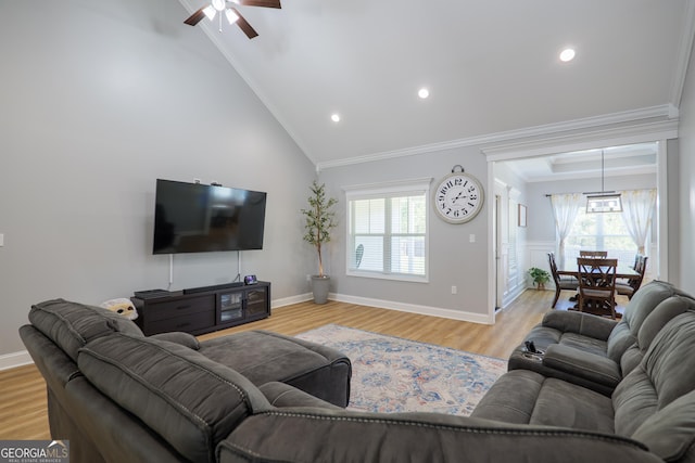 living room featuring light wood finished floors, plenty of natural light, recessed lighting, and ornamental molding