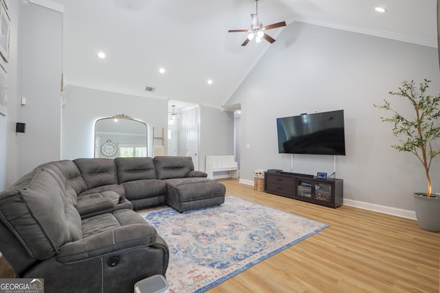 living area featuring crown molding, wood finished floors, baseboards, and high vaulted ceiling