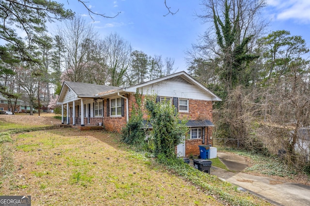 view of front of property with a front yard and brick siding