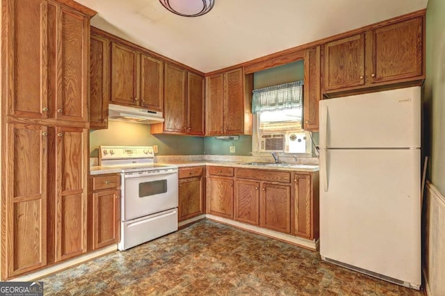 kitchen featuring white appliances, light countertops, brown cabinets, and under cabinet range hood