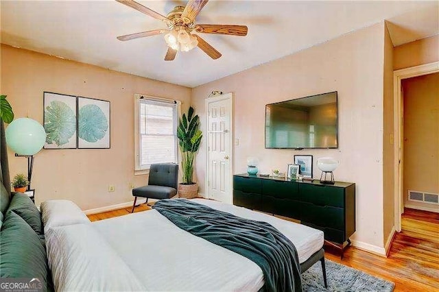 bedroom featuring baseboards, visible vents, and light wood-type flooring