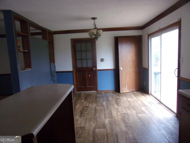 kitchen with an inviting chandelier and wood finished floors