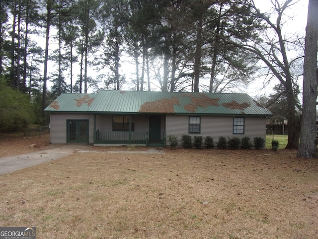 ranch-style house featuring metal roof and covered porch