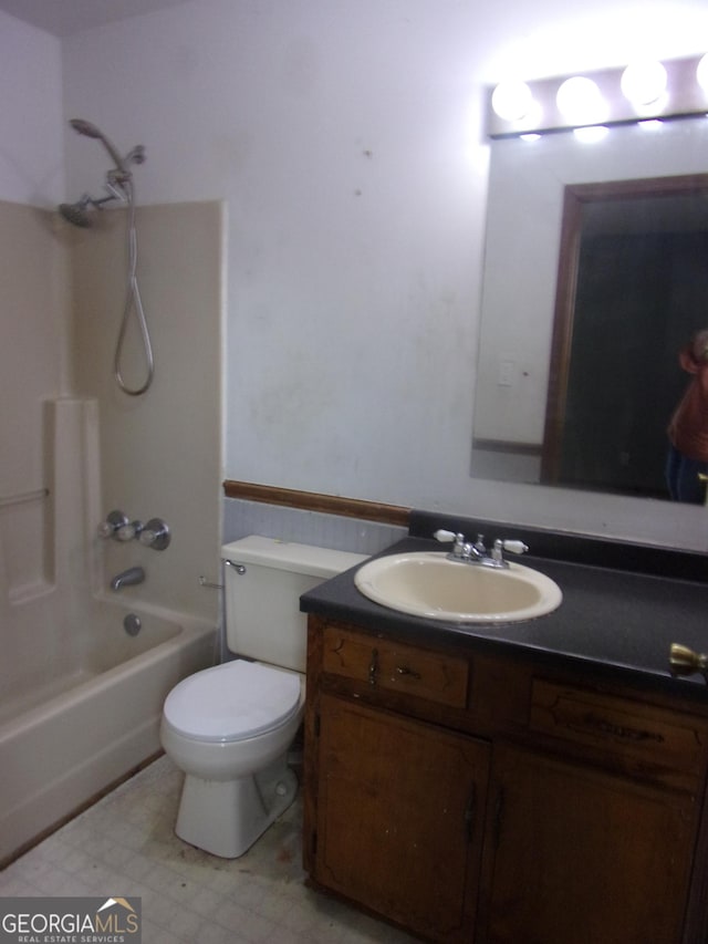 full bathroom with tile patterned floors, toilet, vanity, and washtub / shower combination