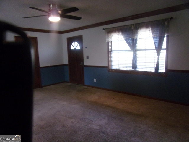 carpeted foyer featuring a ceiling fan