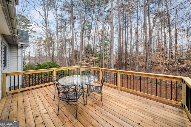 wooden terrace with outdoor dining area