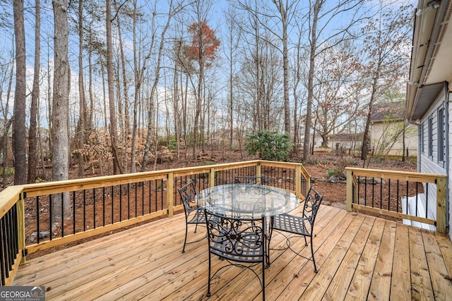 wooden terrace featuring outdoor dining area