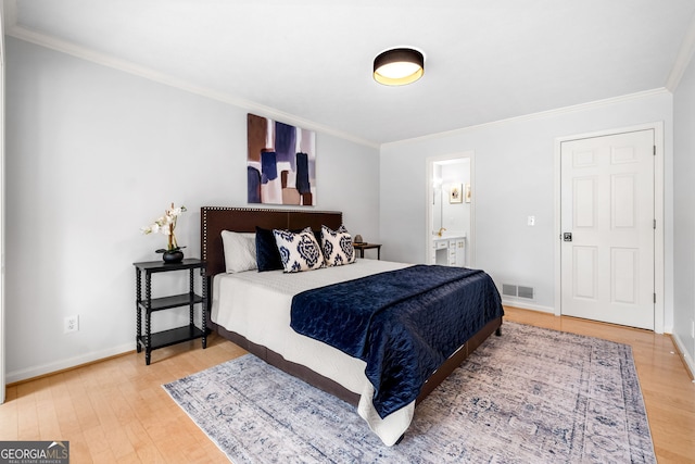 bedroom featuring baseboards, visible vents, light wood finished floors, and ornamental molding