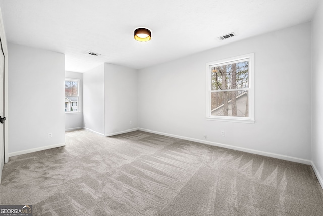 unfurnished bedroom with visible vents, baseboards, and carpet flooring