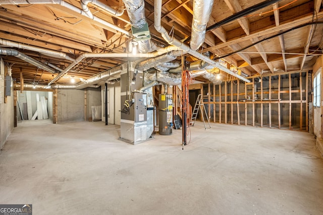 unfinished below grade area featuring gas water heater and heating unit