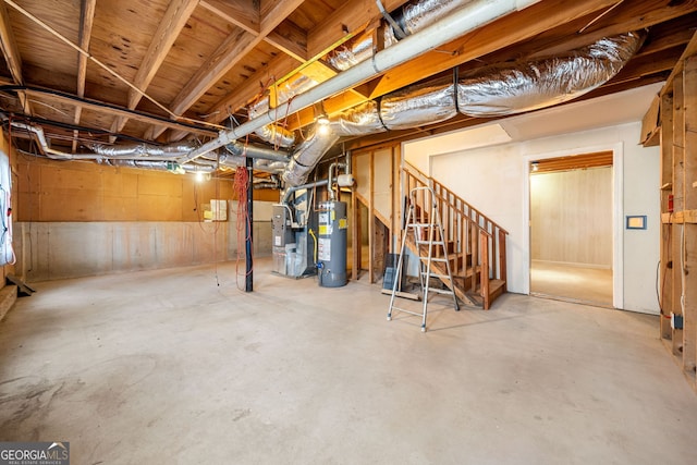 unfinished basement with stairs and water heater