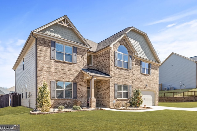 craftsman-style house with a front lawn, concrete driveway, fence, and a garage