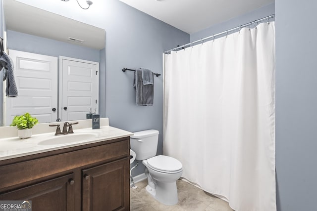 full bathroom featuring vanity, toilet, and visible vents