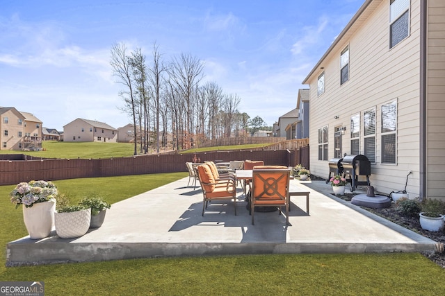 view of patio with a residential view and fence