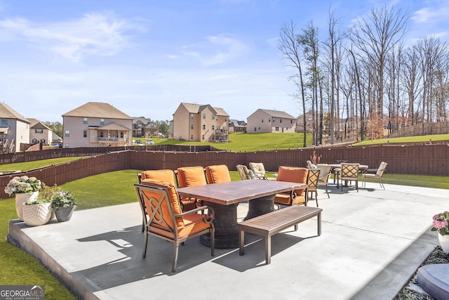 view of patio with outdoor dining area, a fenced backyard, a residential view, and an outdoor hangout area