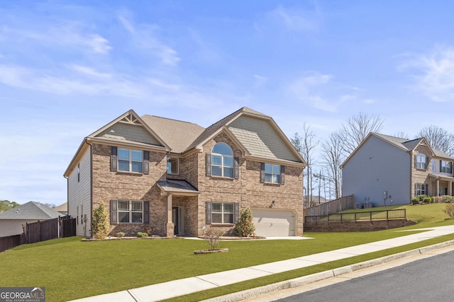 craftsman house with a garage, driveway, a front lawn, and fence