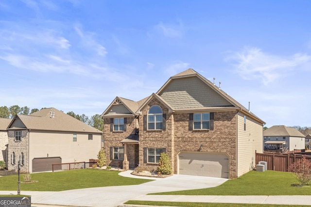 view of front facade featuring a garage, concrete driveway, a front yard, and fence