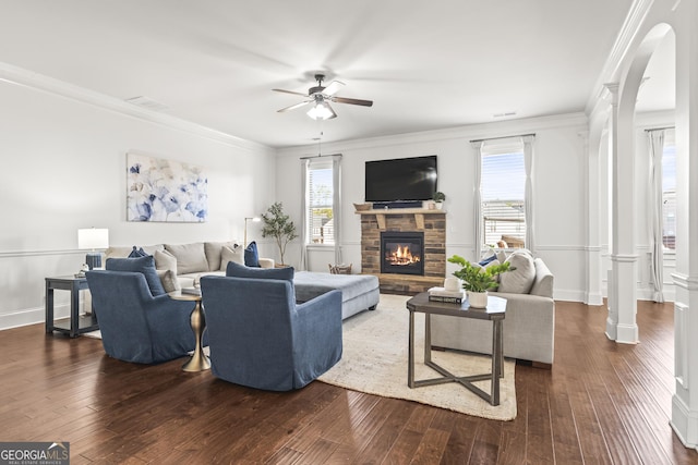 living room featuring dark wood finished floors, a ceiling fan, and crown molding